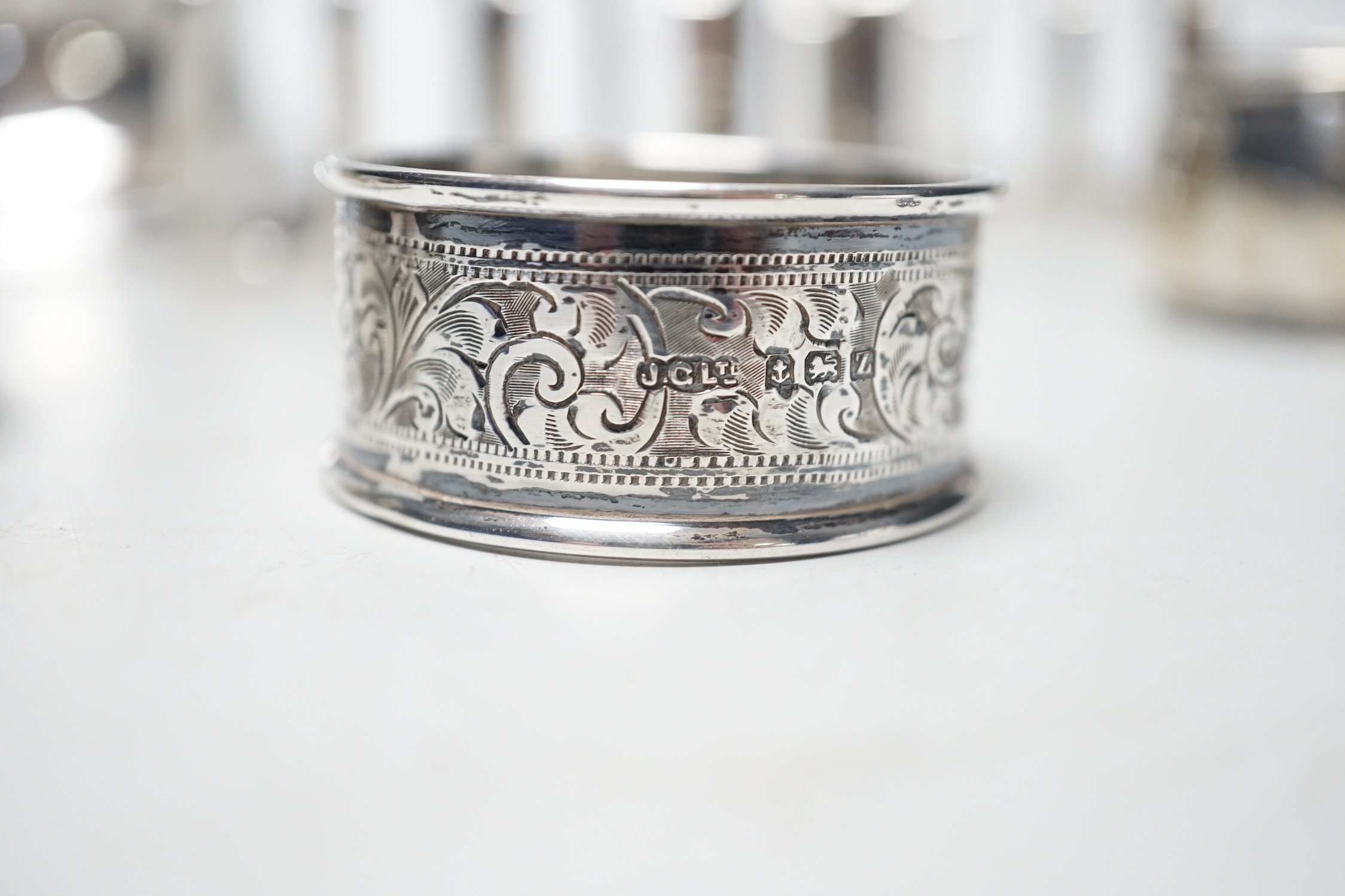 A late Victorian shaped oval silver trinket box, Birmingham, 1898, 99mm, a hexagonal silver pill box, a pair of silver toast racks and four silver serviette rings, a silver domed topped inkwell and a miniature silver two